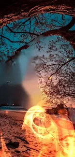 A sunset beach scene framed by tree branches with bright fire elements.