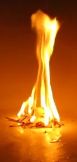 A mobile wallpaper of bright, warm flames against a dark background.