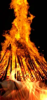 Vibrant bonfire with fiery orange flames on a mobile wallpaper background.