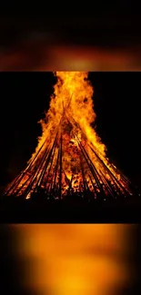 A vibrant bonfire illuminating the night sky.