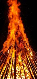 Intense bonfire with vibrant orange flames for mobile wallpaper.