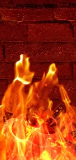 Mobile wallpaper with fiery flames on a rustic brick wall.