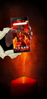 A phone with fiery wallpaper over a red candle flame.