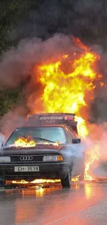 Car on fire in the rain with reflective road.