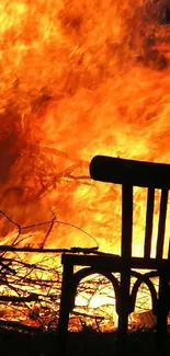 Silhouette of a chair against a blazing fire backdrop.