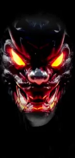 Fiery demon face with glowing red eyes and dark background.