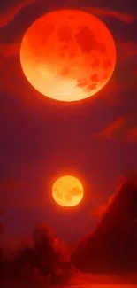 Vibrant orange dual moons over a dramatic landscape wallpaper.