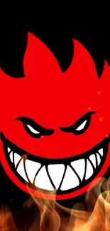 Striking fiery red face emblem with intense grin on a dark background wallpaper.