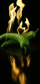 Green chilies engulfed in dancing flames against a black background.