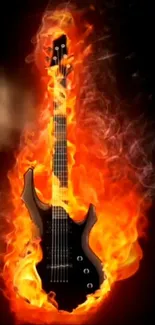 Electric guitar on fire with vibrant orange flames against a black background.