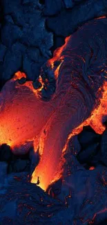 Vibrant orange lava flow over dark rocks.