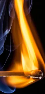 A matchstick engulfed in orange flames against a black background with blue smoke.