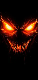 Fiery monster face with glowing eyes and sharp teeth on a black background.