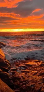 Vibrant fiery ocean sunset with waves crashing.