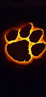 Fiery paw print glowing on a dark background wallpaper.