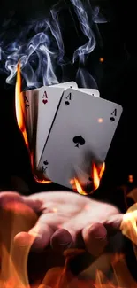 Burning poker aces floating above a hand.