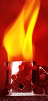 Fiery red lighter with vivid flame against a deep red background.