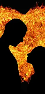 Silhouette couple with fiery heart background.