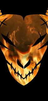 Fiery skull with flames on black mobile wallpaper.