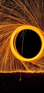 Fiery spiral design with sparks creating dynamic visual art on mobile wallpaper.