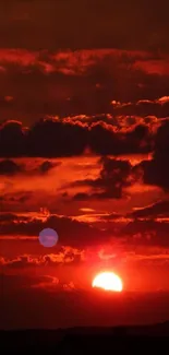 Fiery sunset with red and orange sky over horizon.