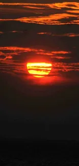 Fiery sunset with orange and red hues illuminating the sky.