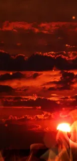 Fiery red sunset with dramatic clouds and a glowing orange sky.