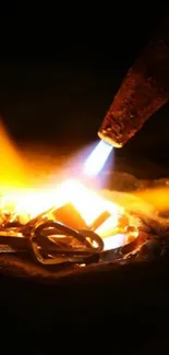 Orange flames with blue torch light on dark backdrop.