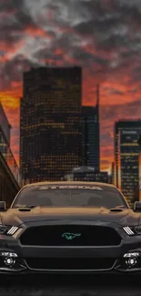 Front view of a car under a fiery sunset urban skyline.