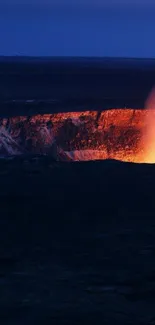 Volcanic eruption with fiery glow against a deep blue night sky.