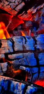 Close-up of fiery burning wood with vivid flames and glowing embers.