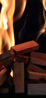 Dynamic mobile wallpaper showing fiery flames over wooden blocks.