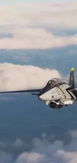 A fighter jet soaring through a cloudy blue sky in high-altitude flight.