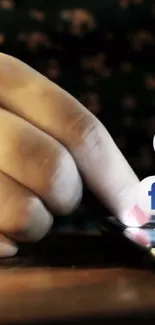 Hand touching smartphone screen with social media icons.