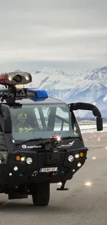 Fire truck navigating snowy mountain runway.