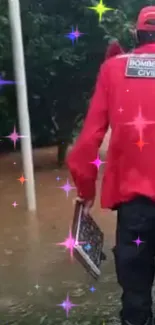 Firefighter in red uniform walks through a flood.