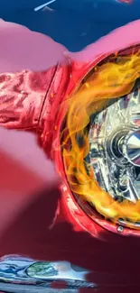 Fiery red car headlight with orange flames.