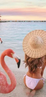 Serene beach with flamingos and a vibrant sunset sky.