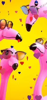 Four inflatable pink flamingos with sunglasses on a bright yellow background.