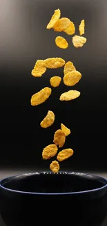 Golden cereal flakes floating above a black bowl on a dark background.