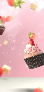 Floating cupcakes and strawberries on a pink background.