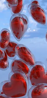 Floating red crystal hearts against a blue sky wallpaper.