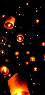 Floating lanterns illuminate the night sky in a stunning display.