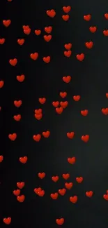 Floating red hearts on a black background wallpaper.