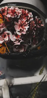 Astronaut helmet filled with flowers and butterflies in artistic wallpaper.