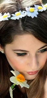 Woman with daisy crown and tranquil gaze.