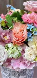 A vibrant bouquet of colorful flowers in soft pink, peach, and cream hues.