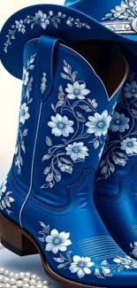 Blue cowboy boots with intricate white floral designs.