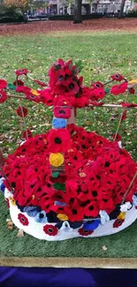 Floral crown centerpiece in park, surrounded by autumn foliage.