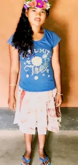 Young woman with floral crown in blue shirt.